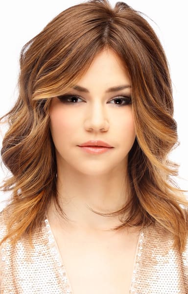 Long feathered smooth layers on face-framing haircut highlighted brunette hair color.