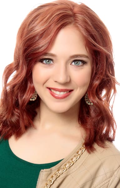 Highlighted red hair color on shoulder length lob haircut.