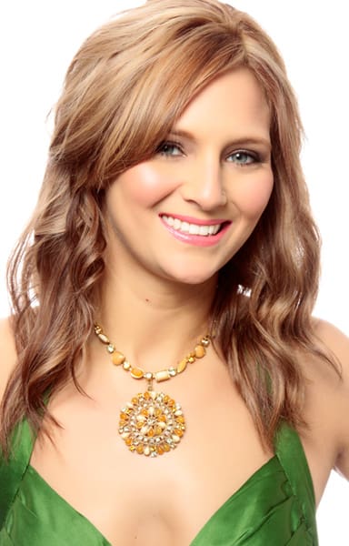 Strawberry blonde hair color with light red and blonde hues on a long layered haircut.