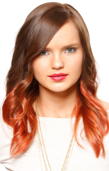 Medium brown to bold coppery red hair color on long layered tresses.